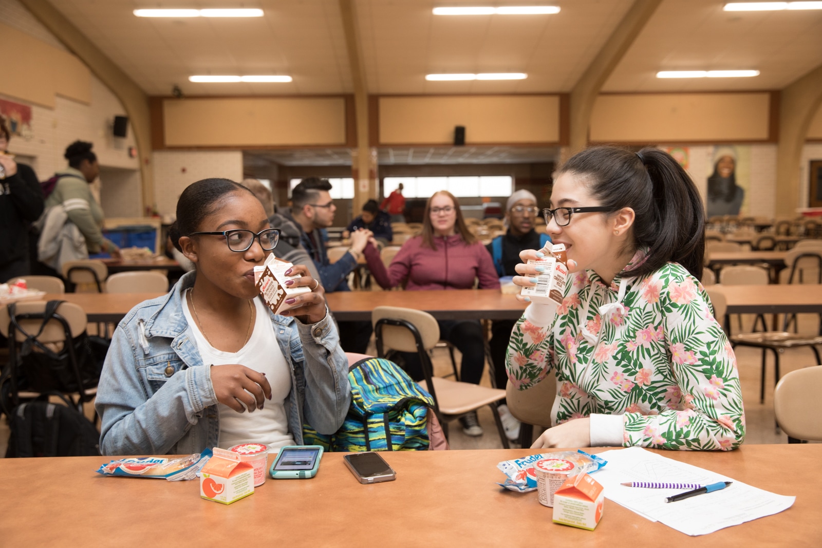 Two young women drinking chocolate milk