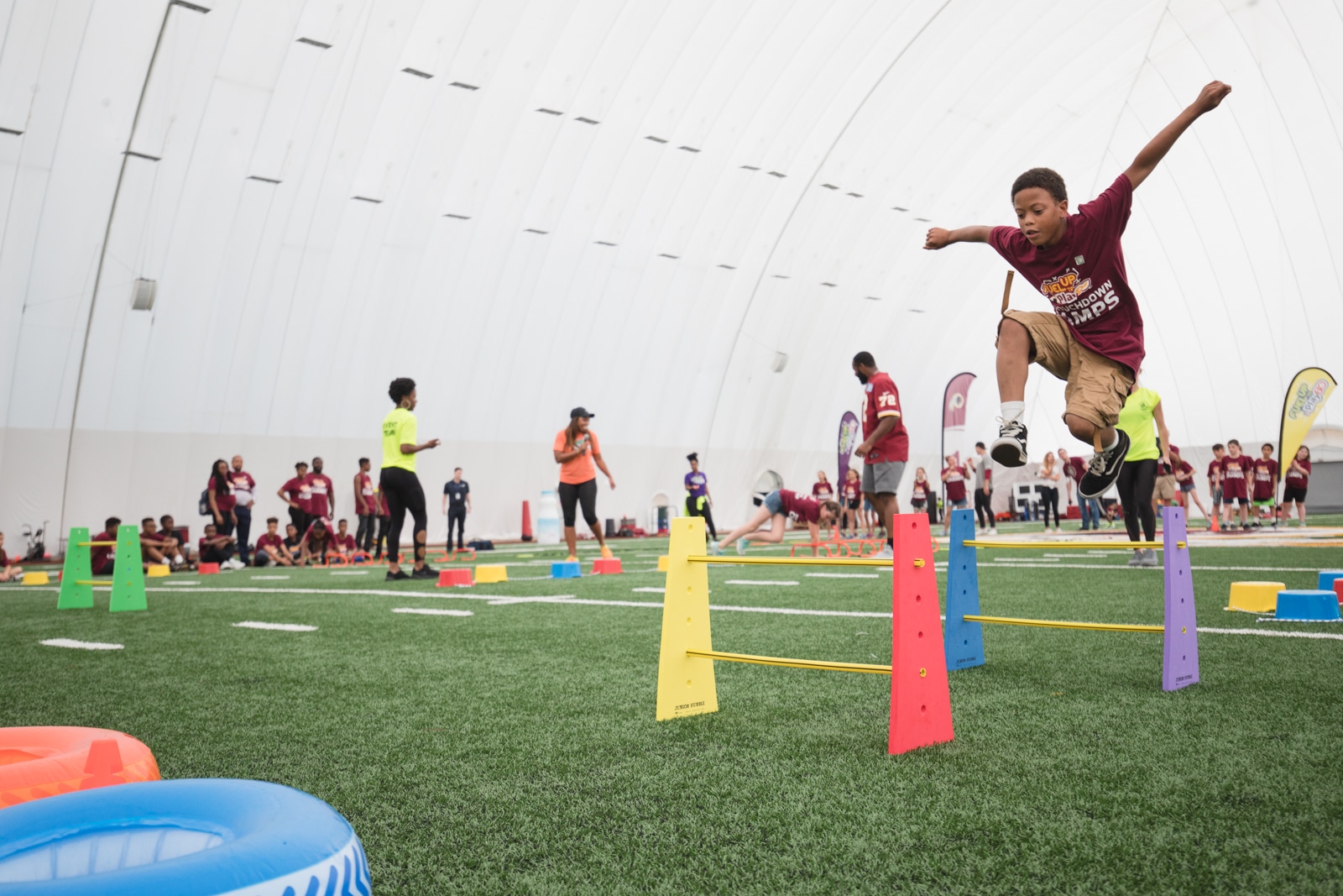 Kid jumping over hurdles