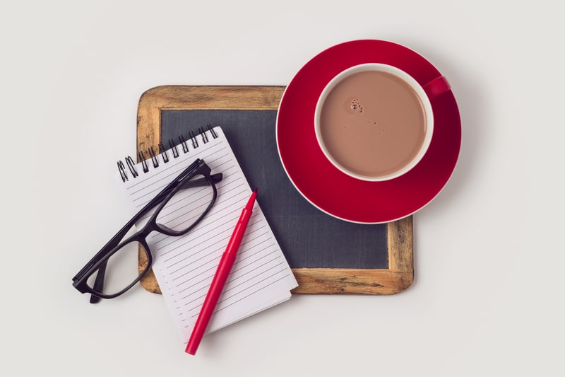 chocolate milk on a desk with work supplies