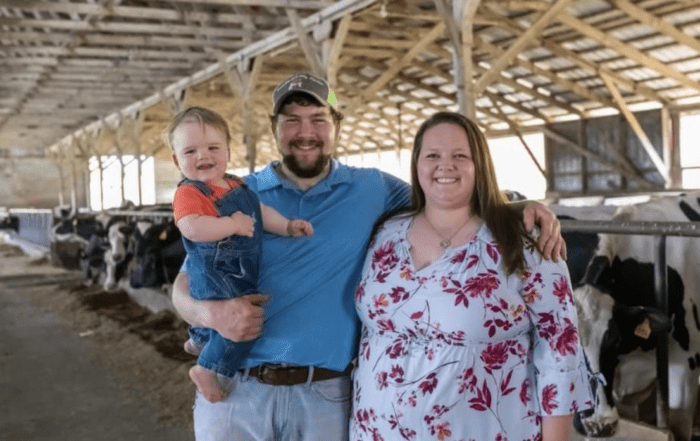 A dairy farming couple and their son inside a barn at Kolb's Farm Store.